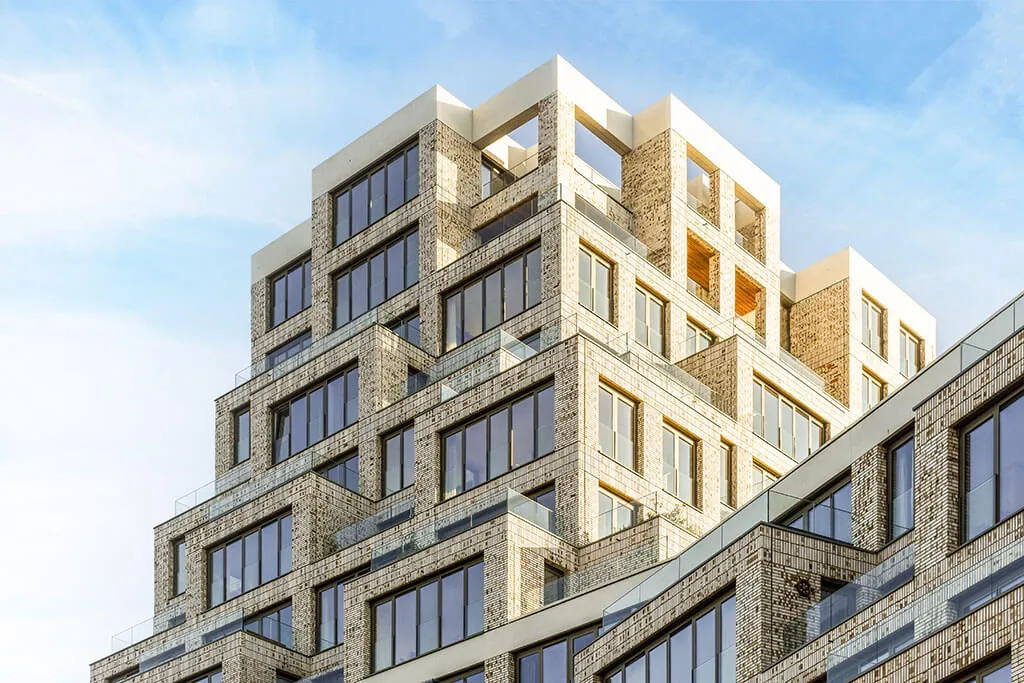Mid-rise residential building with stone-clad facades, a typical ready-mix concrete project
