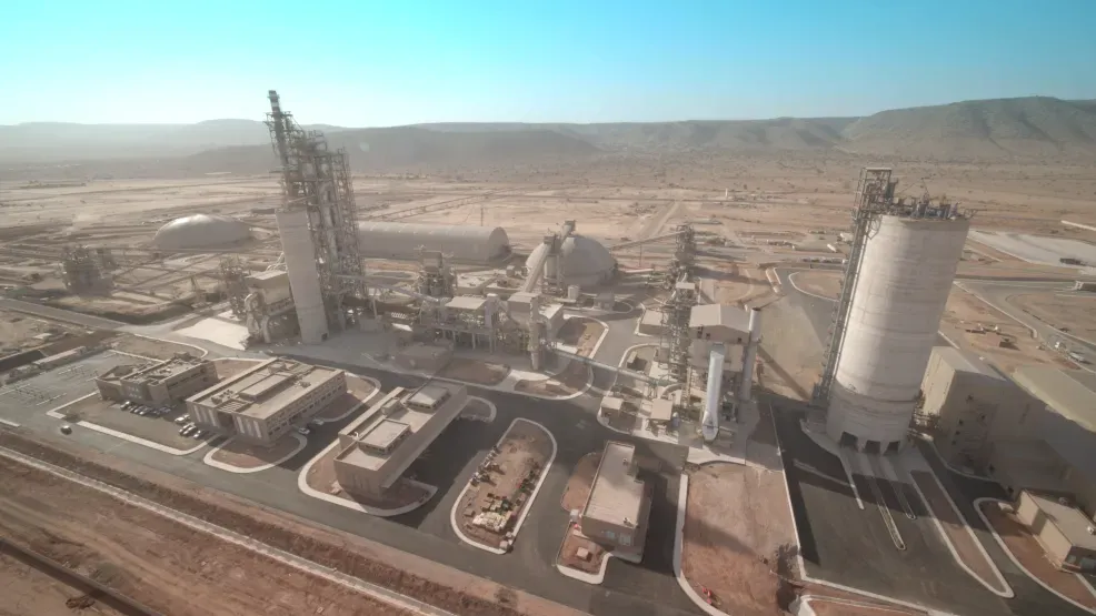 Cement and concrete plant seen from the air, with silos and batching towers